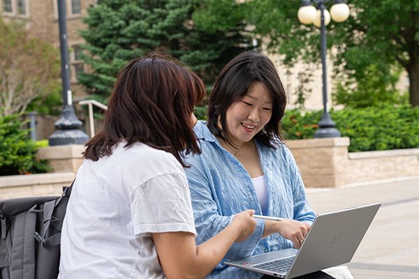 International students looking at a computer together